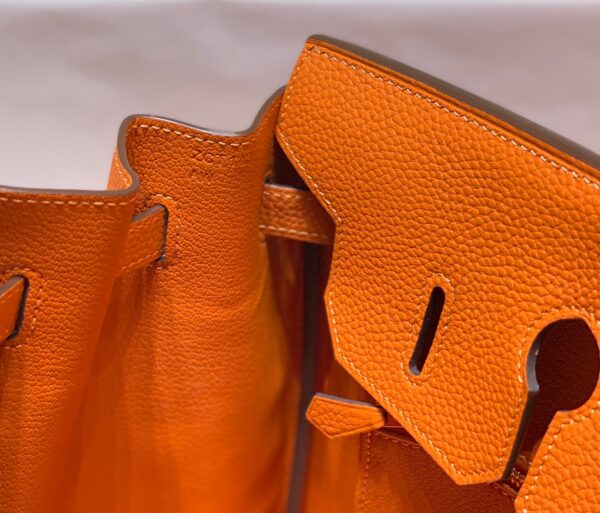 Birkin. Authentic quality luxury bag crafted in genuine leather comes with authenticity card, dust bag and gift bag. Exquisite Craftsmanship and Timeless Elegance: Discover the Allure of the Birkin Bag Large Leather Top Handle. Designed with the actress Jane Birkin in mind, the Birkin bag is a contemporary development of the Kelly bag. Created based on Jane’s suggestions, it was architected to be more significant to fit modern women’s fast-paced life, with several minor yet outstanding adaptations, such as the elongated top handles. The French Birkin 30 bag is a classic touch of elegance to your look! The accessory features a trapeze body, a pebbled leather texture, a hanging key fob, gold-tone hardware, round top handles, a padlock fastening detail, a foldover top with twist-lock closure, a front center logo stamp, an internal zipped pocket, and purse feet.