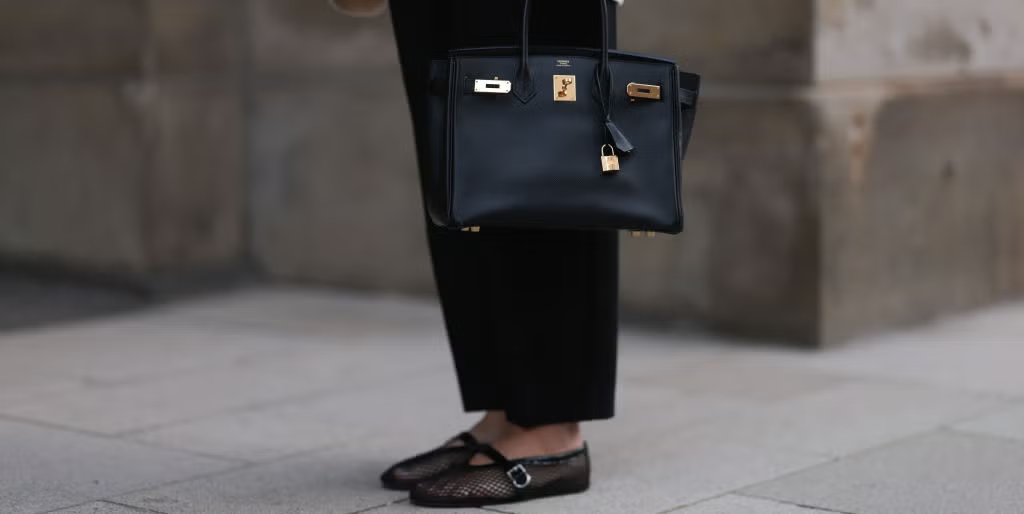 A modern fashion influencer styling a Birkin replica with a streetwear look A modern fashion influencer styling a Birkin replica with a streetwear look